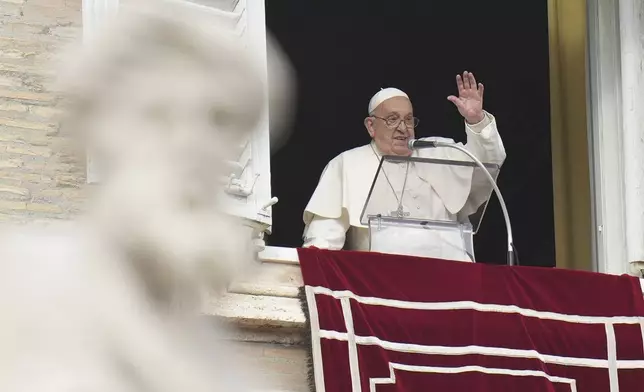 Pope Francis waves during the Angelus noon prayer on the occasion of the Epiphany day from the window of his studio overlooking St.Peter's Square, at the Vatican, Monday, Jan. 6, 2025. (AP Photo/Alessandra Tarantino)