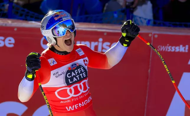Switzerland's Marco Odermatt celebrates at the finish area of an alpine ski, men's World Cup downhill, in Wengen, Switzerland, Saturday, Jan. 18, 2025 (AP Photo/Giovanni Maria Pizzato)