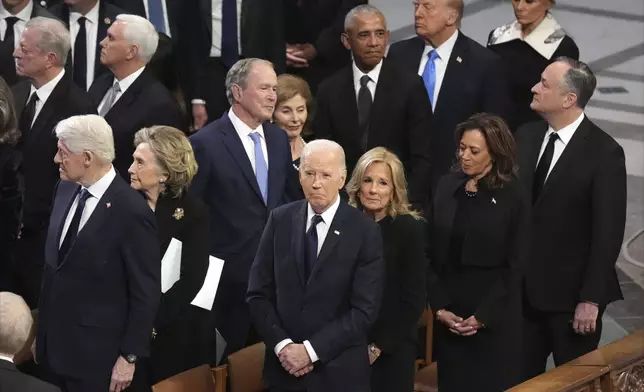 President Joe Biden and first lady Jill Biden watch as the state funeral for former President Jimmy Carter begins at Washington National Cathedral in Washington, Thursday, Jan. 9, 2025. (AP Photo/Jacquelyn Martin)