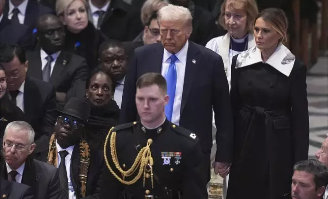 President-elect Donald Trump and Melania Trump arrive before the state funeral for former President Jimmy Carter at Washington National Cathedral in Washington, Thursday, Jan. 9, 2025. (AP Photo/Jacquelyn Martin)