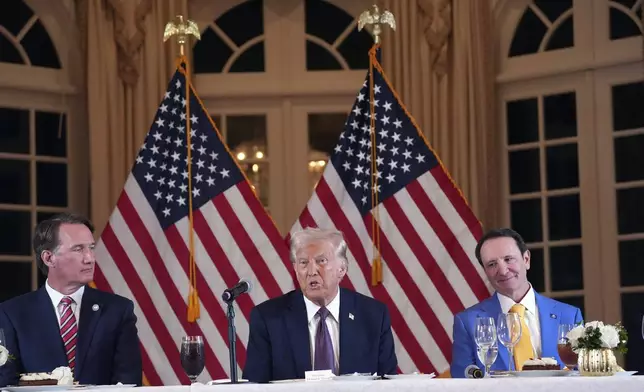 President-elect Donald Trump speaks during a meeting with Republican governors at Mar-a-Lago, Thursday, Jan. 9, 2025, in Palm Beach, Fla., as Virginia Gov. Glenn Youngkin and Louisiana Gov. Jeff Landry listen (AP Photo/Evan Vucci)