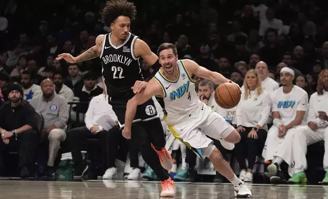 Indiana Pacers' T.J. McConnell (9) drives past Brooklyn Nets' Jalen Wilson (22) during the second half of an NBA basketball game, Monday, Jan. 6, 2025, in New York. (AP Photo/Frank Franklin II)