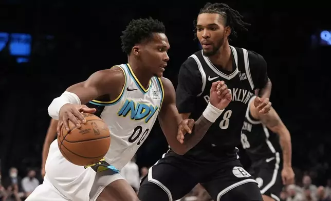 Indiana Pacers' Bennedict Mathurin (00) drives past Brooklyn Nets' Ziaire Williams (8) during the second half of an NBA basketball game, Monday, Jan. 6, 2025, in New York. (AP Photo/Frank Franklin II)