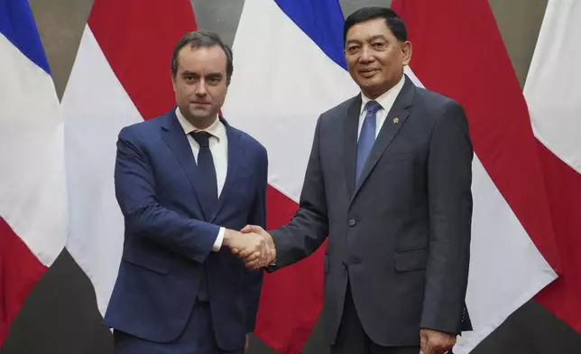 France's Defense Minister Sebastien Lecornu, left, shakes hands with Indonesian Defense Minister Sjafrie Sjamsoeddin during their meeting in Jakarta, Indonesia, Friday, Jan. 31, 2025. (AP Photo/Tatan Syuflana)