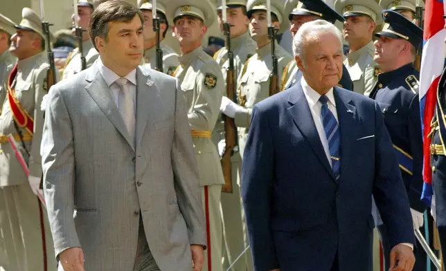 FILE - Georgian President Mikhail Saakashvili, left, and Estonian President Arnold Ruutel review the honor guard in Tbilisi, Georgia, Thursday, May 11, 2006. (AP Photo/Shakh Aivazov, File)