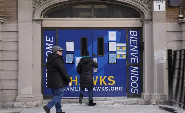 People enter Hamline Elementary School after federal agents were turned away on Friday, Jan. 24, 2025, in Chicago. (AP Photo/Erin Hooley)