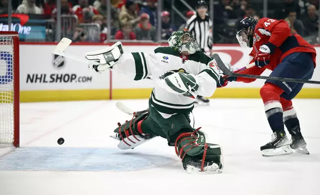 Washington Capitals right wing Tom Wilson (43) scores a goal past Minnesota Wild goaltender Marc-Andre Fleury, left, during the first period of an NHL hockey game, Thursday, Jan. 2, 2025, in Washington. (AP Photo/Nick Wass)