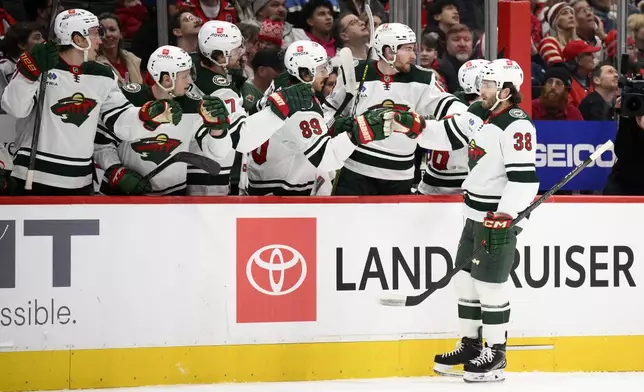 Minnesota Wild right wing Ryan Hartman (38) celebrates his goal during the first period of an NHL hockey game against the Washington Capitals, Thursday, Jan. 2, 2025, in Washington. (AP Photo/Nick Wass)