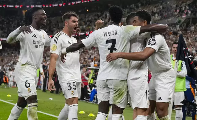 Real Madrid's Jude Bellingham, right, celebrates after scoring his side's opening goal during the Spanish Super Cup semifinal soccer match between Real Madrid and Mallorca at the King Abdullah Stadium in Jeddah, Saudi Arabia, Thursday, Jan. 9, 2025. (AP Photo/Altaf Qadri)