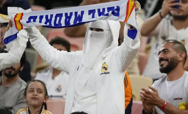 Supporter cheer before the Spanish Super Cup semifinal soccer match between Real Madrid and Mallorca at the King Abdullah Stadium in Jeddah, Saudi Arabia, Thursday, Jan. 9, 2025. (AP Photo/Altaf Qadri)