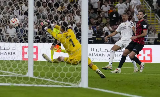 Mallorca's goalkeeper Dominik Greif saves Real Madrid's Kylian Mbappe's shot during the Spanish Super Cup semifinal soccer match between Real Madrid and Mallorca at the King Abdullah Stadium in Jeddah, Saudi Arabia, Thursday, Jan. 9, 2025. (AP Photo/Altaf Qadri)