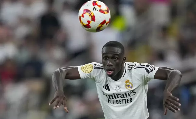 Real Madrid's Ferland Mendy throws the ball during the Spanish Super Cup semifinal soccer match between Real Madrid and Mallorca at the King Abdullah Stadium in Jeddah, Saudi Arabia, Thursday, Jan. 9, 2025. (AP Photo/Altaf Qadri)