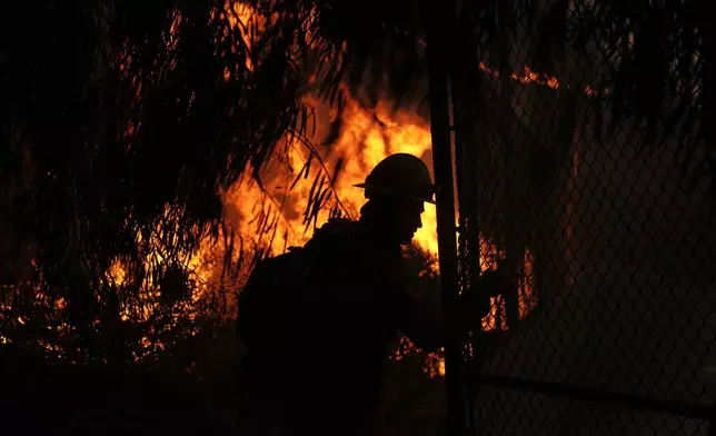 Firefighters look out over the Kenneth Fire, Thursday, Jan. 9, 2025, in the West Hills section of Los Angeles. (AP Photo/Eric Thayer)