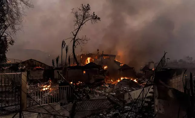 Structures are on fire during the Eaton fire in Altadena, Calif., Wednesday, Jan. 8, 2025. (Stephen Lam/San Francisco Chronicle via AP)