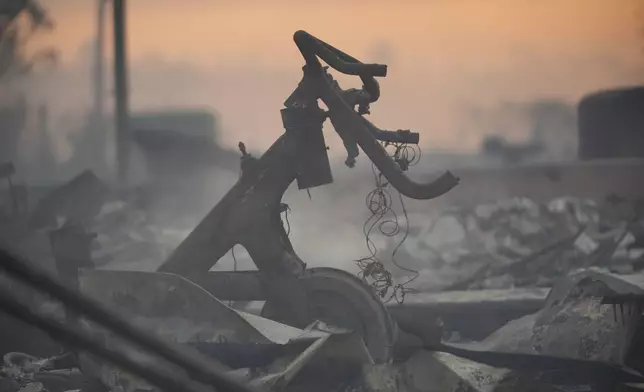 Debris covers the ground after the Palisades Fire ravaged a neighborhood amid high winds in the Pacific Palisades neighborhood of Los Angeles, Thursday, Jan. 9, 2025. (AP Photo/Damian Dovarganes)