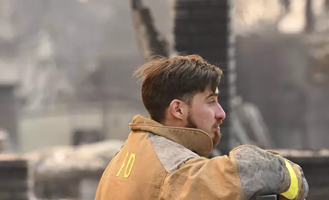 Robert Lara looks through his home that was destroyed after the Eaton Fire burns in Altadena, Calif., Thursday, Jan. 9, 2025. (AP Photo/Nic Coury)