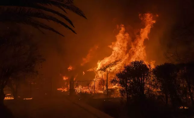 A house burns in the Eaton Fire in Altadena, Calif., Wednesday, Jan. 8, 2025. (AP Photo/Nic Coury)