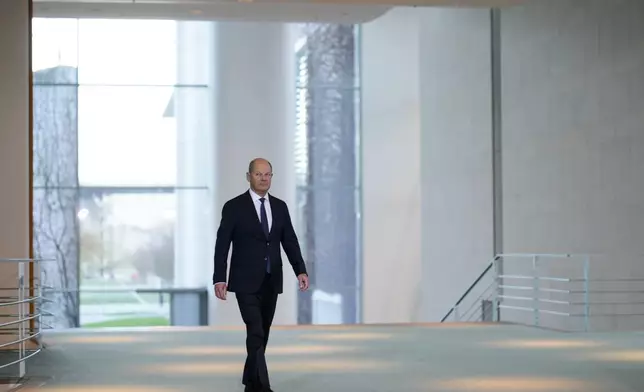 German Chancellor Olaf Scholz arrives for a statement at the chancellery in Berlin, Germany, Wednesday, Jan. 8, 2025. (AP Photo/Markus Schreiber)