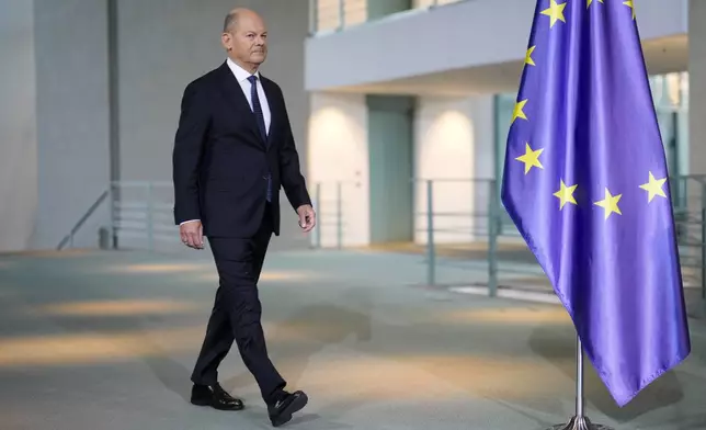 German Chancellor Olaf Scholz arrives for a statement at the chancellery in Berlin, Germany, Wednesday, Jan. 8, 2025. (AP Photo/Markus Schreiber)