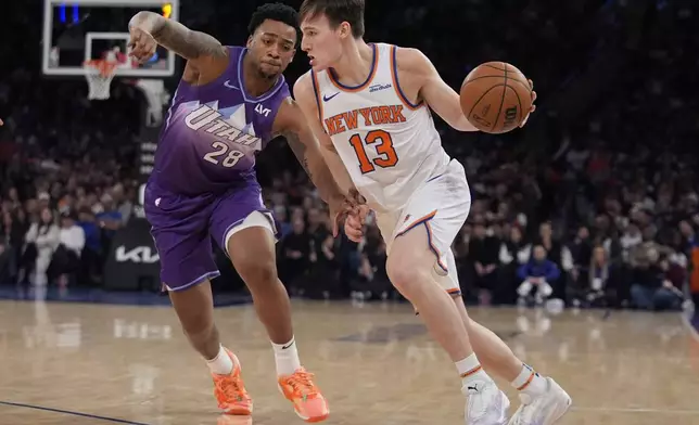 New York Knicks' Tyler Kolek (13) drives past Utah Jazz's Brice Sensabaugh (28) during the second half of an NBA basketball game Wednesday, Jan. 1, 2025, in New York. (AP Photo/Frank Franklin II)