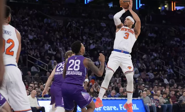 New York Knicks' Josh Hart (3) shoots over Utah Jazz's Brice Sensabaugh (28) and Lauri Markkanen (23) during the second half of an NBA basketball game Wednesday, Jan. 1, 2025, in New York. (AP Photo/Frank Franklin II)