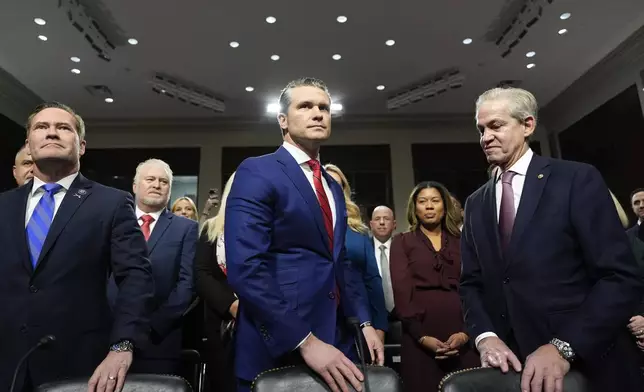 Pete Hegseth, center, President-elect Donald Trump's choice to be Defense secretary, appears before the Senate Armed Services Committee for his confirmation hearing with Rep. Michael Waltz, R-Fla., left, and former Sen. Norm Coleman, at the Capitol in Washington, Tuesday, Jan. 14, 2025. (AP Photo/Alex Brandon)
