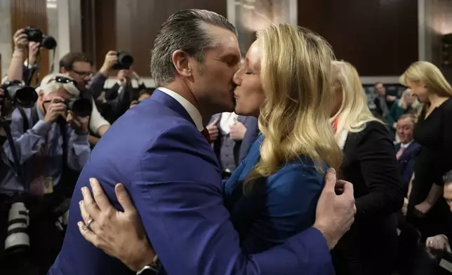 Pete Hegseth, President-elect Donald Trump's choice to be Defense secretary, embraces his wife Jennifer Rauche at the completion of a Senate Armed Services Committee hearing for his confirmation, at the Capitol in Washington, Tuesday, Jan. 14, 2025. (AP Photo/Ben Curtis)