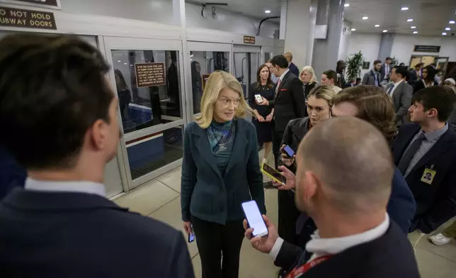 Sen. Lisa Murkowski, R-Alaska, talks with reporters as she makes her way through the Senate subway at the Capitol, Thursday, Jan. 23, 2025, in Washington. (AP Photo/Rod Lamkey, Jr.)