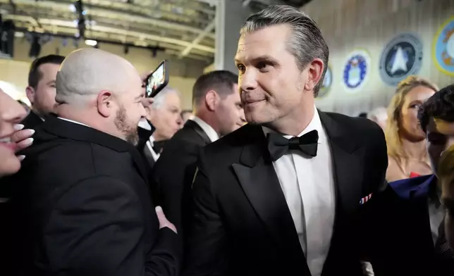 Defense Secretary nominee Pete Hegseth, center, attends the Commander in Chief Ball, Monday, Jan. 20, 2025, in Washington, after the 60th Presidential Inauguration. (AP Photo/Alex Brandon)