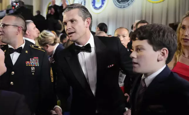 Defense Secretary nominee Pete Hegseth, center, attends the Commander in Chief Ball, Monday, Jan. 20, 2025, in Washington, after the 60th Presidential Inauguration. (AP Photo/Alex Brandon)