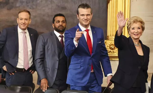 From left, Lee Zeldin, administrator of the Environmental Protection Agency nominee; Kash Patel, FBI director nominee; Pete Hegseth, secretary of defense nominee; and Linda McMahon, education secretary nominee; gesture after the 60th Presidential Inauguration in the Rotunda of the U.S. Capitol in Washington, Monday, Jan. 20, 2025. (Chip Somodevilla/Pool Photo via AP)