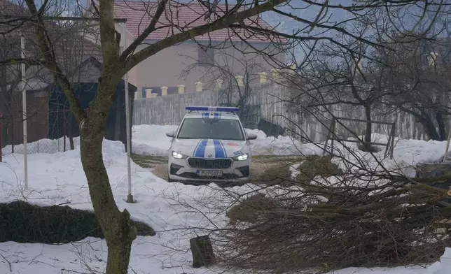 A police car outside a house after a shooting incident, in Cetinje, 36 kilometers (22 miles) west of Podogrica, Montenegro, Thursday, Jan. 2, 2025. (AP Photo/Risto Bozovic)