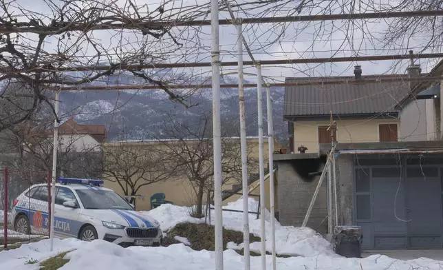 A view of a police vehicle at the home of a gunman after a shooting incident, in Cetinje, 36 kilometers (22 miles) west of Podogrica, Montenegro, Thursday, Jan. 2, 2025. (AP Photo/Risto Bozovic)