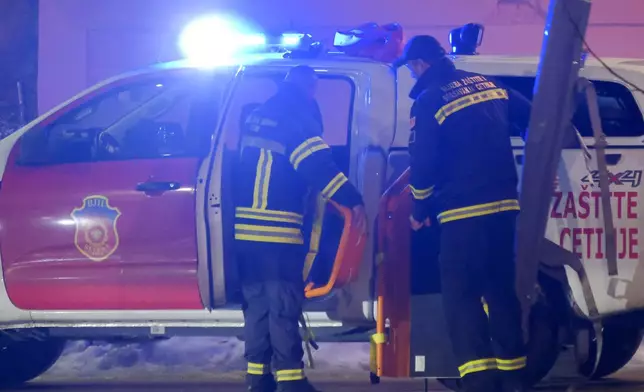 Rescue workers work at the site of a shooting in Cetinje, 36 kilometers (22 miles) west of Podogrica, Montenegro, Wednesday, Jan 1, 2025. (AP Photo/Risto Bozovic)