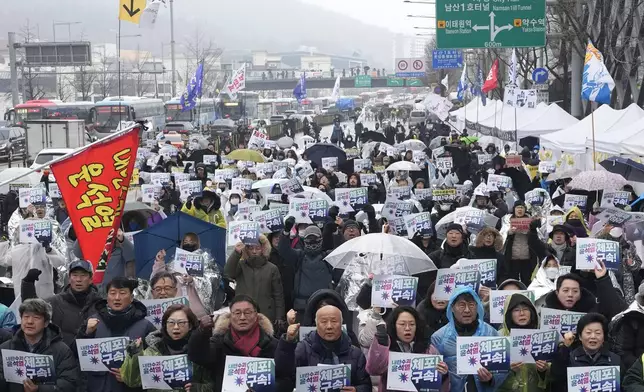 Protesters stage a rally demanding the arrest of impeached South Korean President Yoon Suk Yeol near the presidential residence in Seoul, South Korea, Monday, Jan. 6, 2025. The letters read "Arrest Yoon Suk Yeol." (AP Photo/Ahn Young-joon)