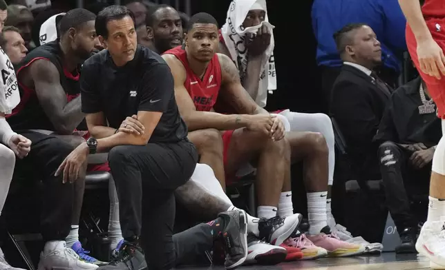 Miami Heat head coach Erik Spoelstra, front left, watches the second half of an NBA basketball game against the Utah Jazz, Saturday, Jan. 4, 2025, in Miami. (AP Photo/Lynne Sladky)