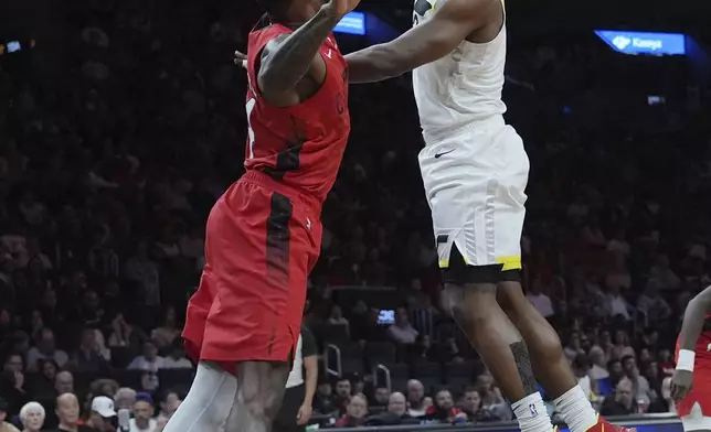 Utah Jazz forward Brice Sensabaugh, right, shoots as Miami Heat forward Haywood Highsmith, left, defends during the second half of an NBA basketball game Saturday, Jan. 4, 2025, in Miami. (AP Photo/Lynne Sladky)