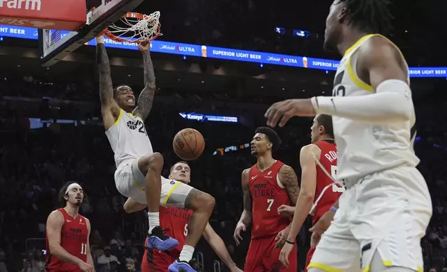 Utah Jazz forward John Collins (20) dunks during the second half of an NBA basketball game against the Miami Heat, Saturday, Jan. 4, 2025, in Miami. (AP Photo/Lynne Sladky)