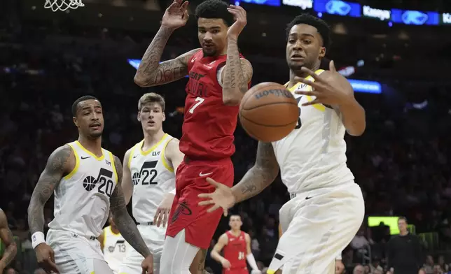 Utah Jazz forward Brice Sensabaugh (28) goes for a loose ball as Miami Heat center Kel'el Ware (7) lost control of the ball during the first half half of an NBA basketball game Saturday, Jan. 4, 2025, in Miami. (AP Photo/Lynne Sladky)