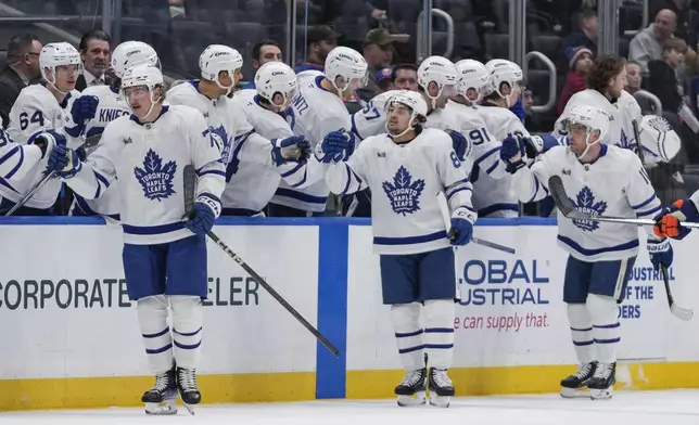 Toronto Maple Leafs' Bobby McMann (74) celebrates with teammates after scoring a goal during the second period of an NHL hockey game against the New York Islanders, Thursday, Jan. 2, 2025, in Elmont, N.Y. (AP Photo/Frank Franklin II)