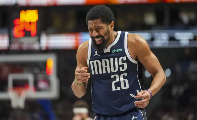 Dallas Mavericks guard Spencer Dinwiddie reacts after coming in contact with Denver Nuggets forward Michael Porter Jr. on a play during the first half of an NBA basketball game, Sunday, Jan. 12, 2025, in Dallas. (AP Photo/Julio Cortez)