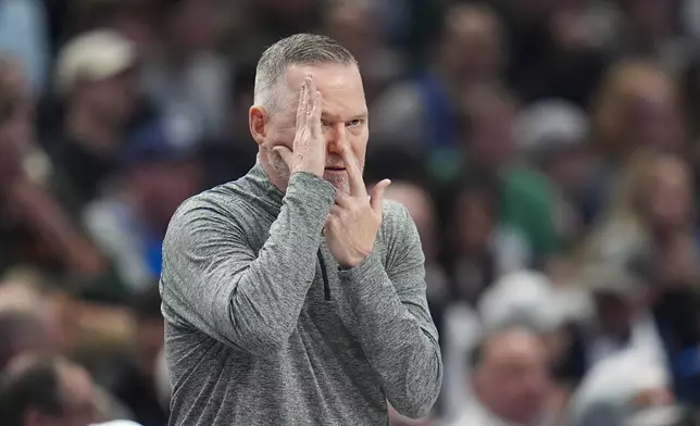 Denver Nuggets head coach Michael Malone gestures toward guard Russell Westbrook, not visible, during the first half of an NBA basketball game against the Dallas Mavericks, Sunday, Jan. 12, 2025, in Dallas. (AP Photo/Julio Cortez)