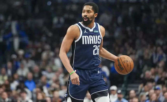 Dallas Mavericks guard Spencer Dinwiddie works the floor against the Denver Nuggets during the first half of an NBA basketball game, Sunday, Jan. 12, 2025, in Dallas. (AP Photo/Julio Cortez)