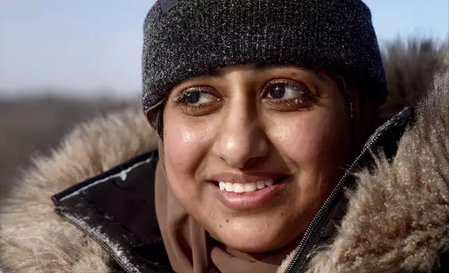 Ruqayah Nasser takes a break after her first snow tubing runs in below-zero cold during an outing organized by a Minnesota group promoting outdoors activities by Muslim women, at Elm Creek Park Reserve in Maple Grove, Minn., on Jan. 4, 2025. (AP Photo/Mark Vancleave)