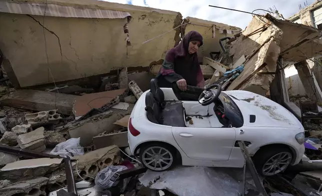 FILE - Mariam Kourani removes a toy car from the rubble of her destroyed house after returning with her family to the Hanouiyeh village in southern Lebanon, on Nov. 28, 2024, following a ceasefire between Israel and Hezbollah. (AP Photo/Hussein Malla, File)