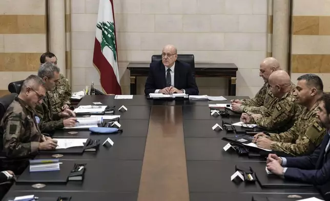 FILE - Lebanese caretaker Prime Minister Najib Mikati, center, meets with the committee monitoring the Lebanon-Israel ceasefire, at the government palace in Beirut, Lebanon, on Dec. 24, 2024. (AP Photo/Bilal Hussein, File)