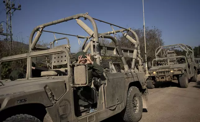 FILE - An Israeli soldier gestures from his vehicle in northern Israel, near the border with Lebanon, on Dec. 3, 2024. (AP Photo/Maya Alleruzzo, File)