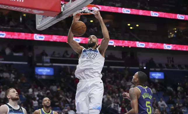 Minnesota Timberwolves center Rudy Gobert (27) slam dunks over New Orleans Pelicans guard Dejounte Murray (5) in the first half of an NBA basketball game in New Orleans, Tuesday, Jan. 7, 2025. (AP Photo/Gerald Herbert)