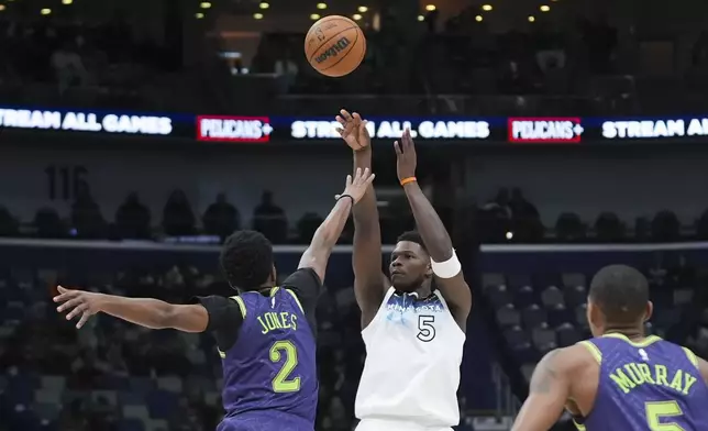 Minnesota Timberwolves guard Anthony Edwards (5) shoots against New Orleans Pelicans forward Herbert Jones (2) in the first half of an NBA basketball game in New Orleans, Tuesday, Jan. 7, 2025. (AP Photo/Gerald Herbert)