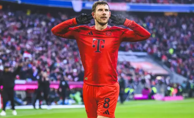 Munich's Leon Goretzka celebrates after scoring the opening goal during the German Bundesliga soccer match between FC Bayern Munich and VfL Wolfsburg in Munich, Germany, Saturday, Jan. 18, 2025. (Tom Weller/dpa via AP)